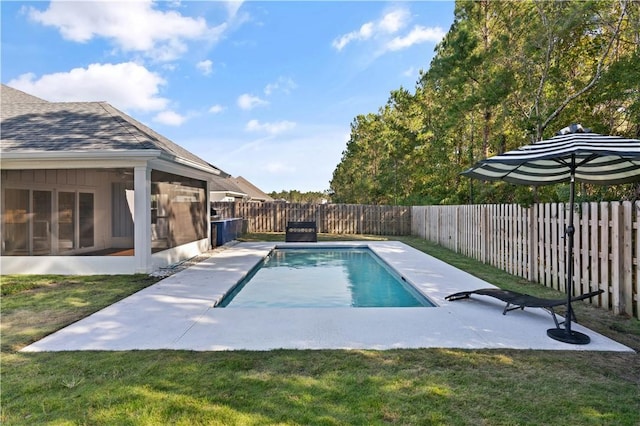 view of swimming pool featuring a sunroom and a yard