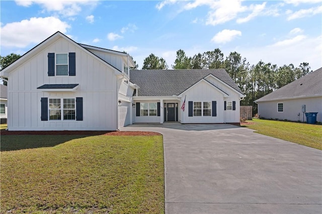 view of front of home with a front lawn and a garage