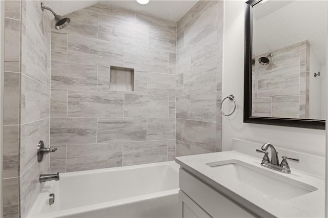 bathroom featuring vanity and tiled shower / bath