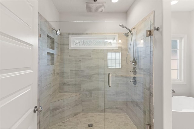 bathroom featuring a shower with door