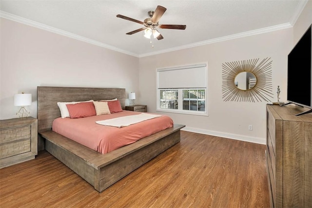 bedroom featuring wood-type flooring, ceiling fan, and ornamental molding