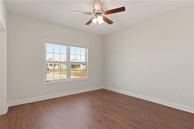 spare room with ceiling fan and dark hardwood / wood-style flooring