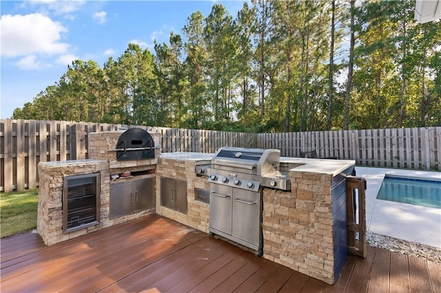 exterior space with area for grilling, a pool side deck, and a grill