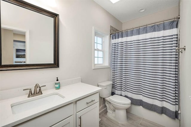 full bathroom featuring a textured ceiling, vanity, toilet, and shower / bathtub combination with curtain