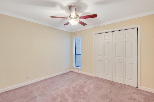 unfurnished bedroom featuring baseboards, ornamental molding, and light colored carpet