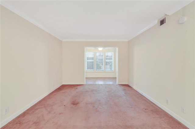 unfurnished room featuring ornamental molding, carpet flooring, visible vents, and baseboards