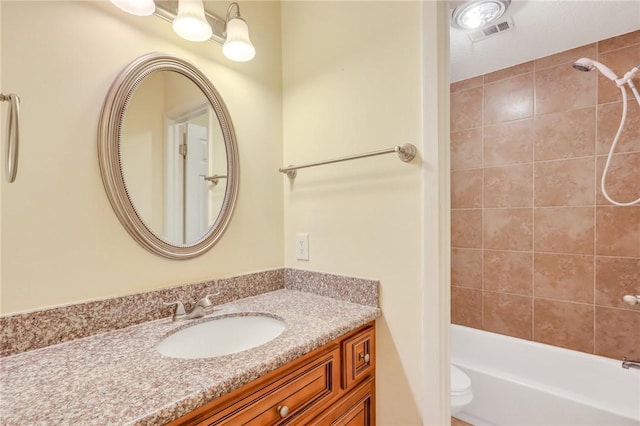 full bath with visible vents, bathtub / shower combination, vanity, and toilet