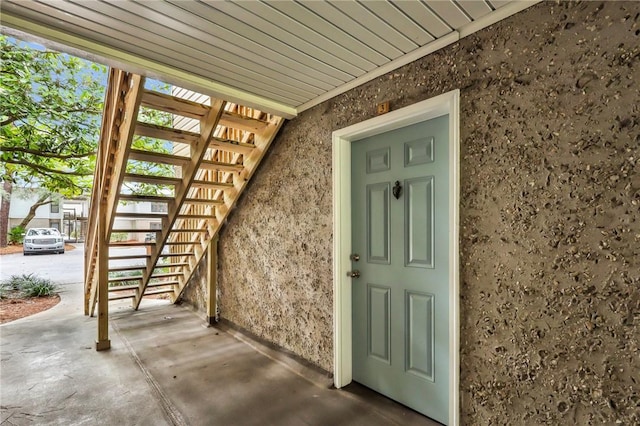 property entrance with stucco siding