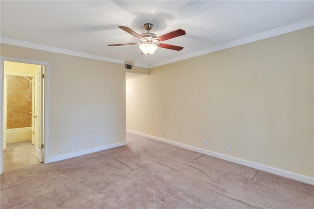 unfurnished room with light carpet, crown molding, and baseboards