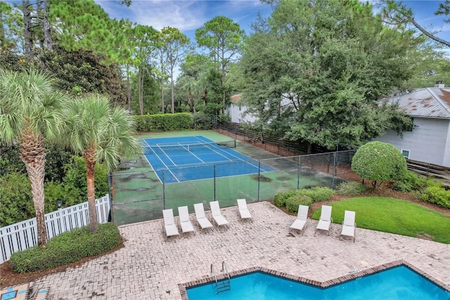 view of sport court featuring a fenced in pool, fence, and a patio