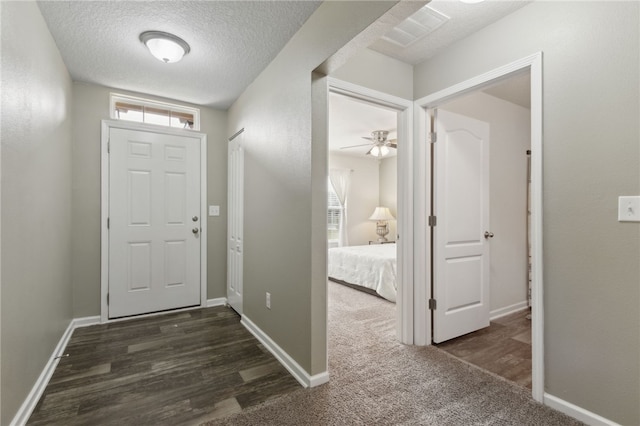 310 Brooklet Cir, Saint Marys, GA 31558 - foyer featuring a textured ceiling, baseboards, and wood finished floors