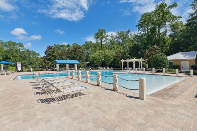 310 Brooklet Cir, Saint Marys, GA 31558 - community pool featuring a pergola, view of scattered trees, and a patio area