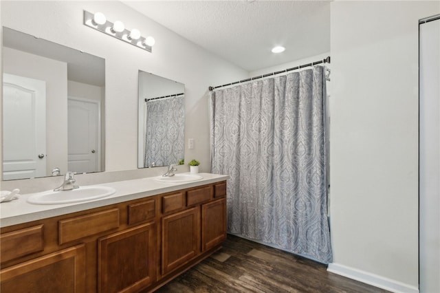 310 Brooklet Cir, Saint Marys, GA 31558 - bathroom with wood finished floors, double vanity, and a textured ceiling