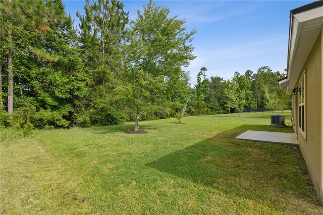 310 Brooklet Cir, Saint Marys, GA 31558 - view of grassy yard featuring cooling unit and a patio area