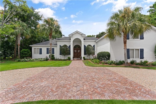 mediterranean / spanish-style house with a front yard and stucco siding