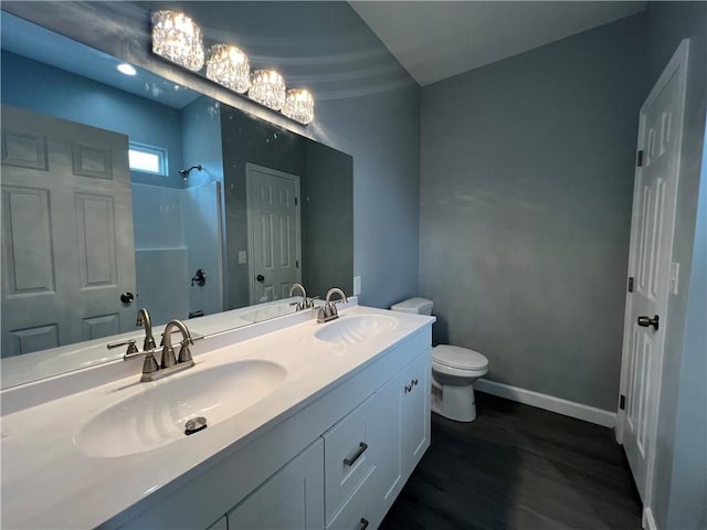 909 E Third St, Darien, GA 31305 - bathroom with a shower, wood finished floors, and double vanity