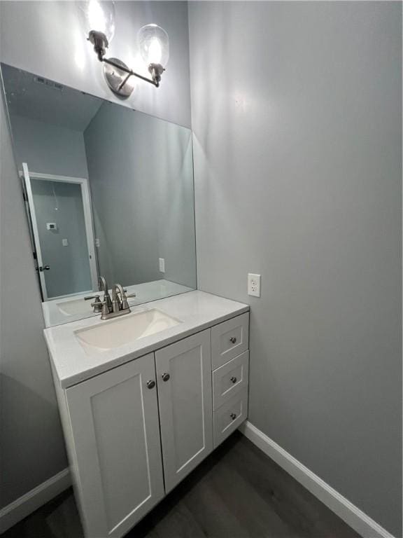 909 E Third St, Darien, GA 31305 - bathroom featuring vanity and wood finished floors