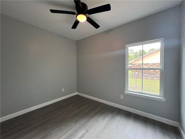 909 E Third St, Darien, GA 31305 - spare room with dark wood-style floors and a ceiling fan