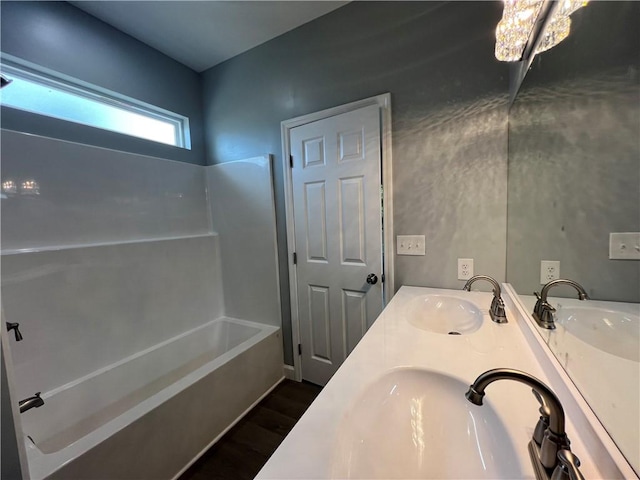 909 E Third St, Darien, GA 31305 - bathroom with wood finished floors, double vanity, and  shower combination