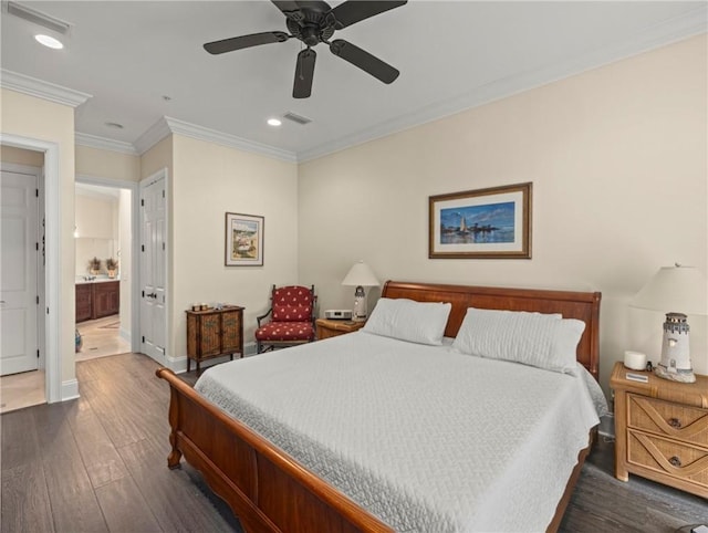 bedroom with dark wood-type flooring, ceiling fan, connected bathroom, and crown molding