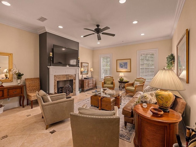 living room with ceiling fan, ornamental molding, and a high end fireplace