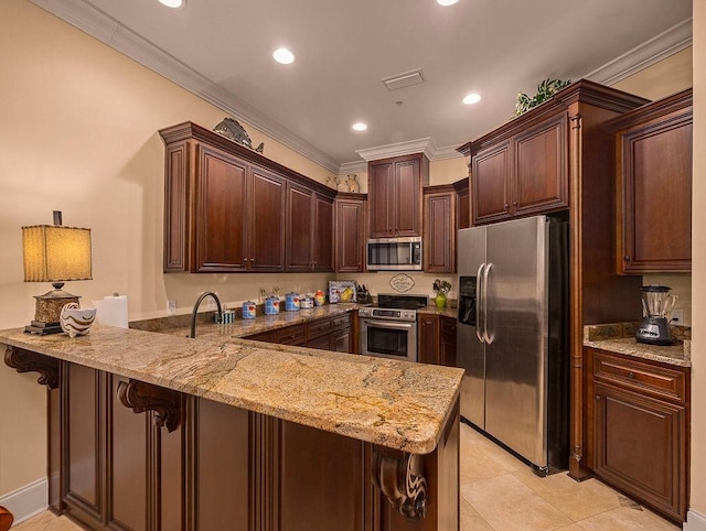 kitchen featuring a kitchen bar, dark brown cabinetry, kitchen peninsula, stainless steel appliances, and crown molding