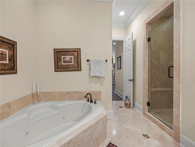 bathroom featuring ornamental molding and separate shower and tub