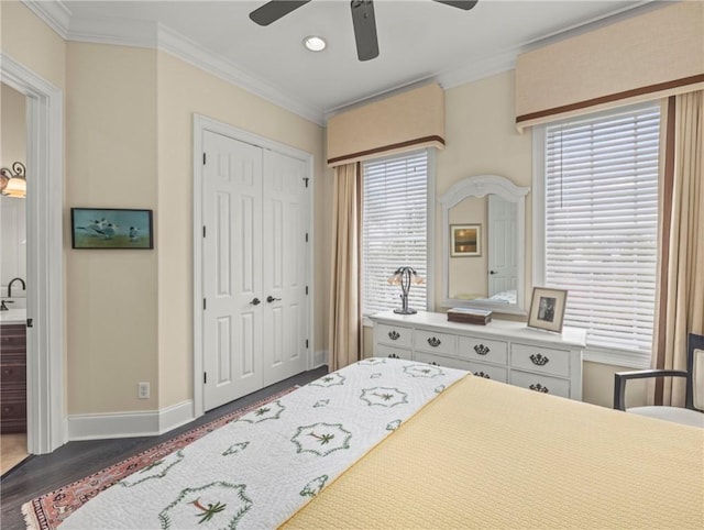 bedroom featuring multiple windows, ornamental molding, dark wood-type flooring, and a closet