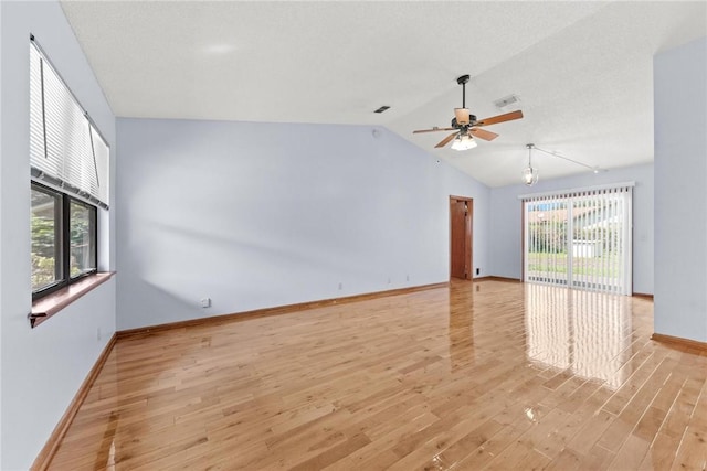 empty room with light wood-type flooring, ceiling fan, and lofted ceiling