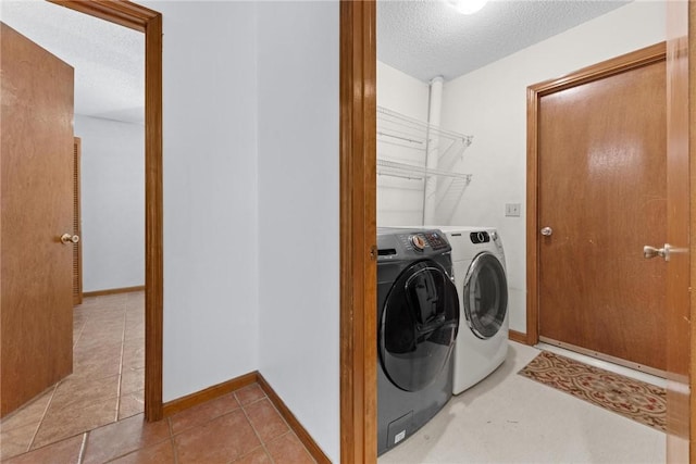 clothes washing area featuring a textured ceiling and separate washer and dryer