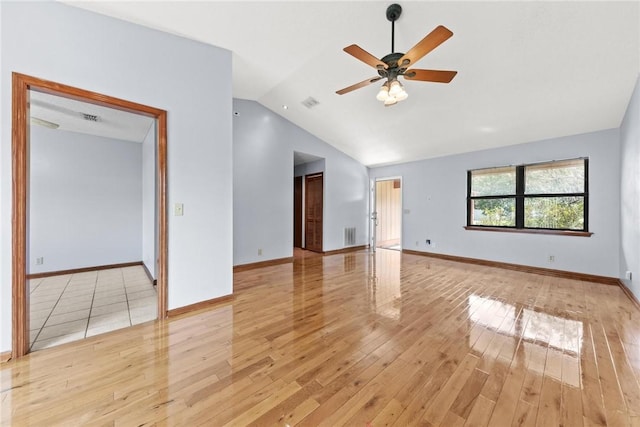 empty room with ceiling fan, lofted ceiling, and light wood-type flooring