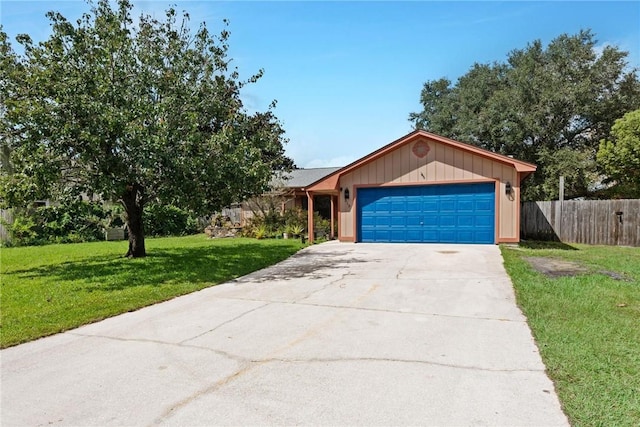 ranch-style home featuring a front lawn and a garage