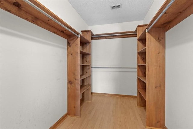 walk in closet featuring light hardwood / wood-style flooring