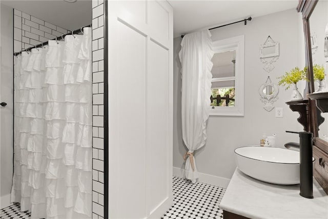 full bathroom with baseboards, vanity, and a shower with curtain