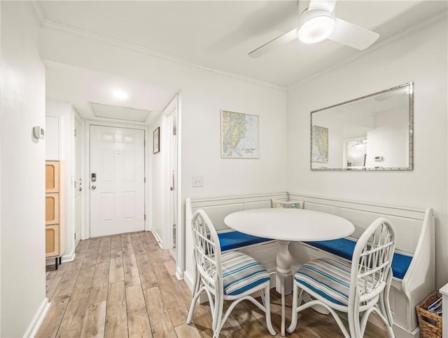 1524 Wood Ave Unit 106, Saint Simons Island, GA 31522 - dining room featuring ceiling fan, baseboards, ornamental molding, and wood finished floors