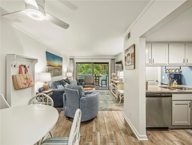 1524 Wood Ave Unit 106, Saint Simons Island, GA 31522 - living area featuring visible vents, ornamental molding, and light wood-type flooring