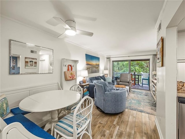 1524 Wood Ave Unit 106, Saint Simons Island, GA 31522 - dining area featuring ornamental molding, a ceiling fan, light wood-type flooring, and visible vents