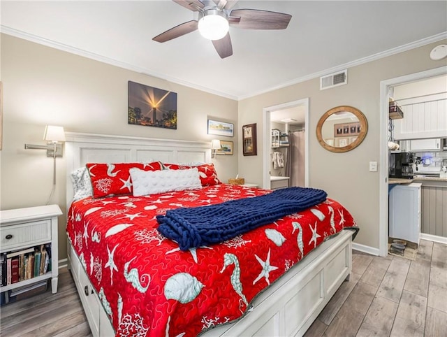 1524 Wood Ave Unit 106, Saint Simons Island, GA 31522 - bedroom with baseboards, ornamental molding, wood finished floors, and visible vents