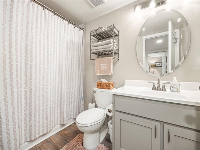 1524 Wood Ave Unit 106, Saint Simons Island, GA 31522 - full bathroom with visible vents, wood finished floors, toilet, and vanity