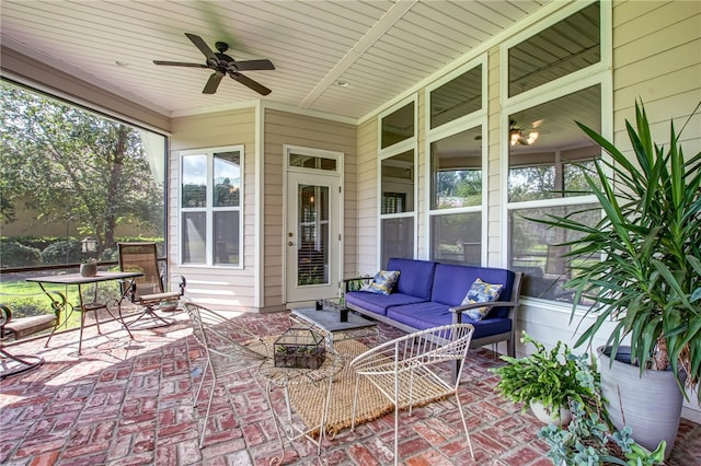 sunroom featuring ceiling fan and a healthy amount of sunlight