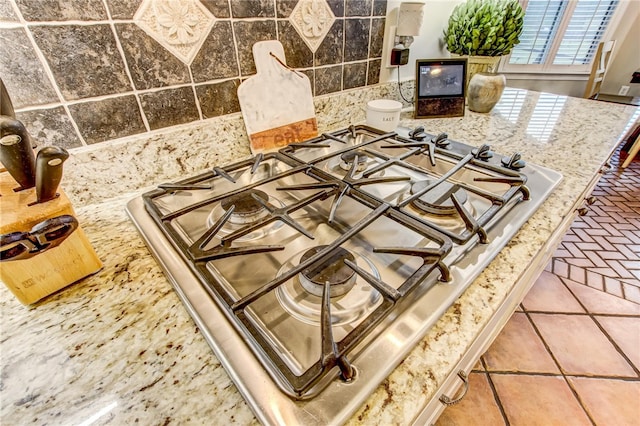 details with stone counters and stainless steel gas cooktop