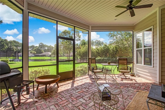 sunroom / solarium featuring ceiling fan and wooden ceiling