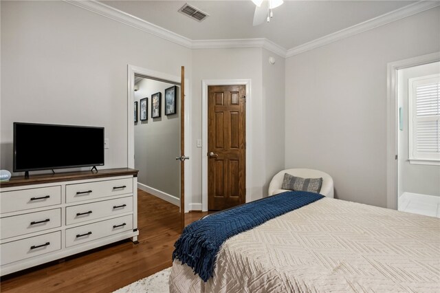 bedroom featuring ornamental molding, ceiling fan, and dark wood-type flooring