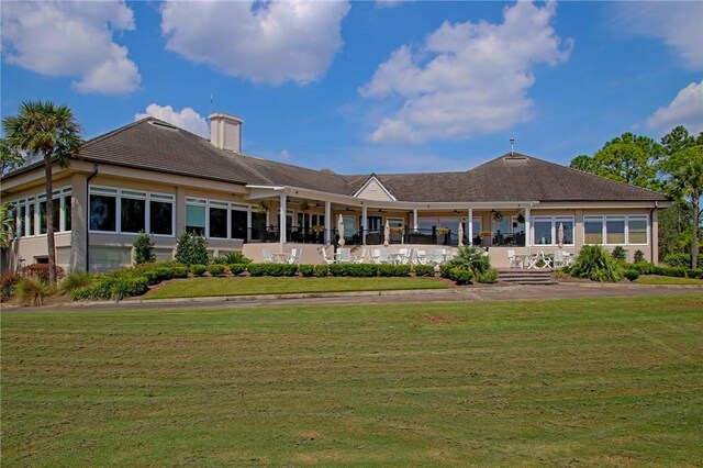 rear view of property featuring a yard