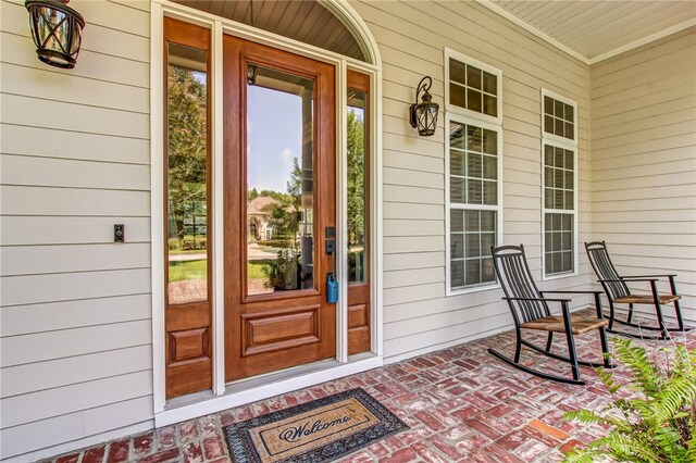 view of exterior entry featuring a porch