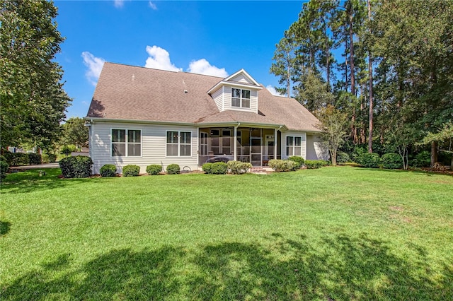 back of house with a lawn and a sunroom