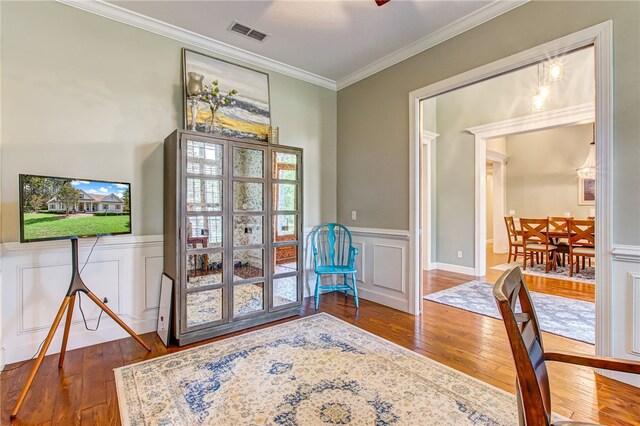 interior space with hardwood / wood-style flooring and ornamental molding