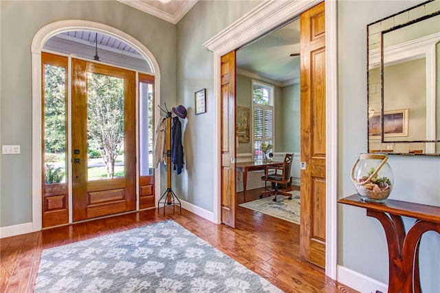 foyer featuring hardwood / wood-style flooring and crown molding