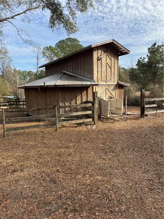 view of side of home featuring an outdoor structure