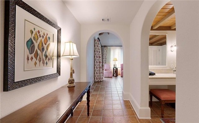 hallway featuring beam ceiling